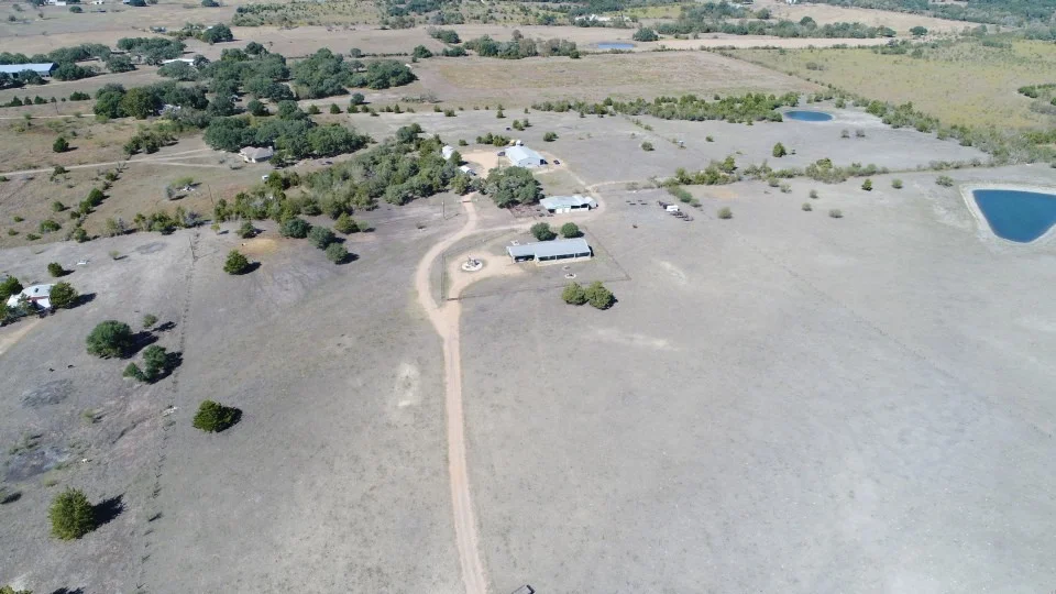Aerial view of the Central Texas landscape, fields, trees, and a pond