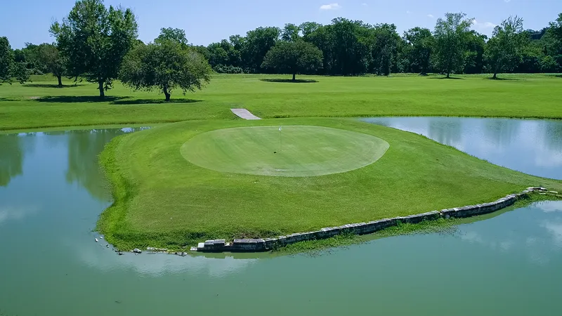 Golf green surrounded by water at the country club